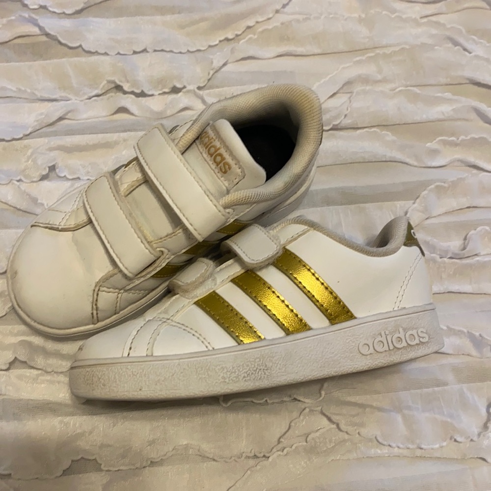 Gold stripe Adidas sneakers